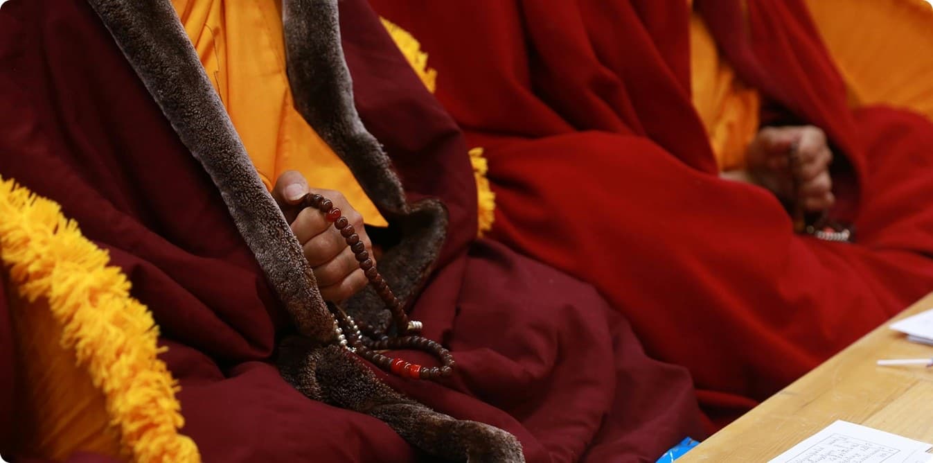 Monks seated with prayer beads